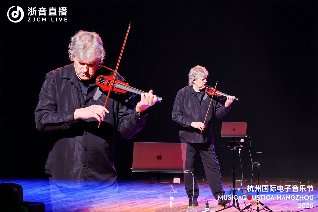Two superimposed views of Mark Zaki performing violin and live electronics at Musicacoustica-Hangzhou